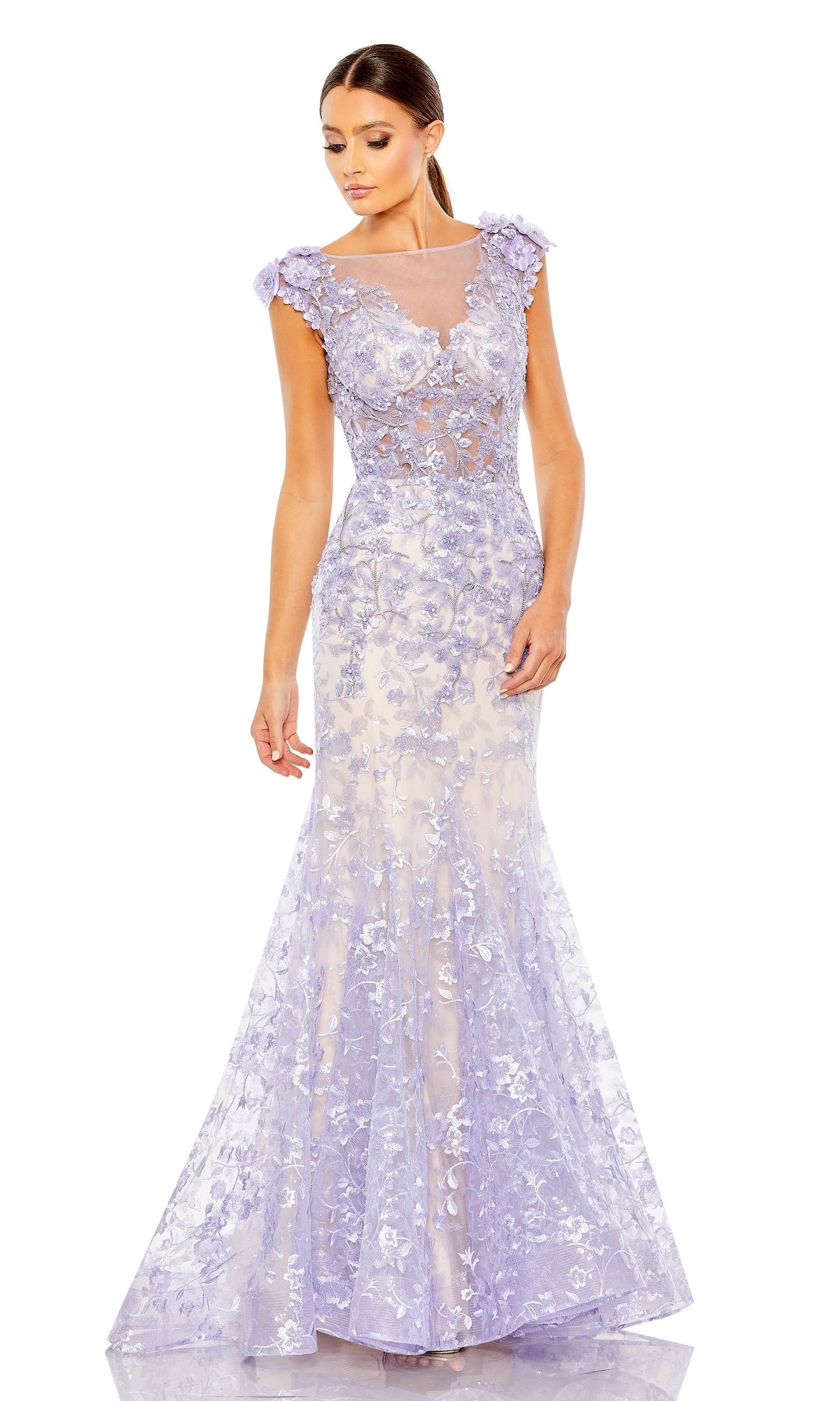 A woman wearing the Long Formal Dress 79357 by Mac Duggal—a floor-length lilac mermaid gown with floral lace, cap sleeves, and a sheer illusion v-neckline—stands against a white background.